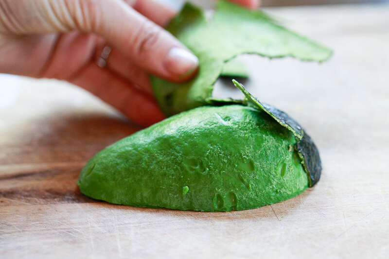 Half an avocado is peeled.