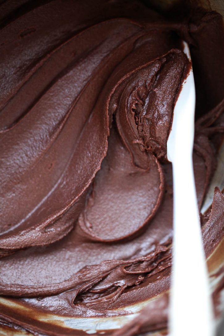 A close-up photo of a homemade dairy-free vegan chocolate frosting. 