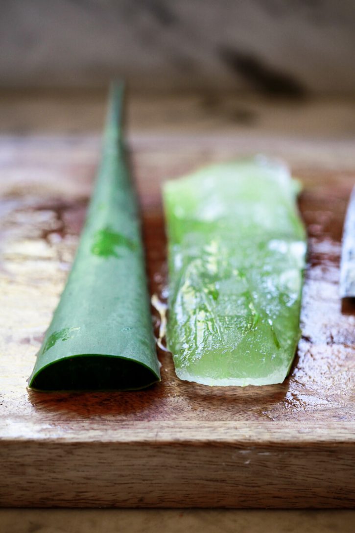 An aloe vera leaf gets peeled to reveal the inner aloe vera gel. 