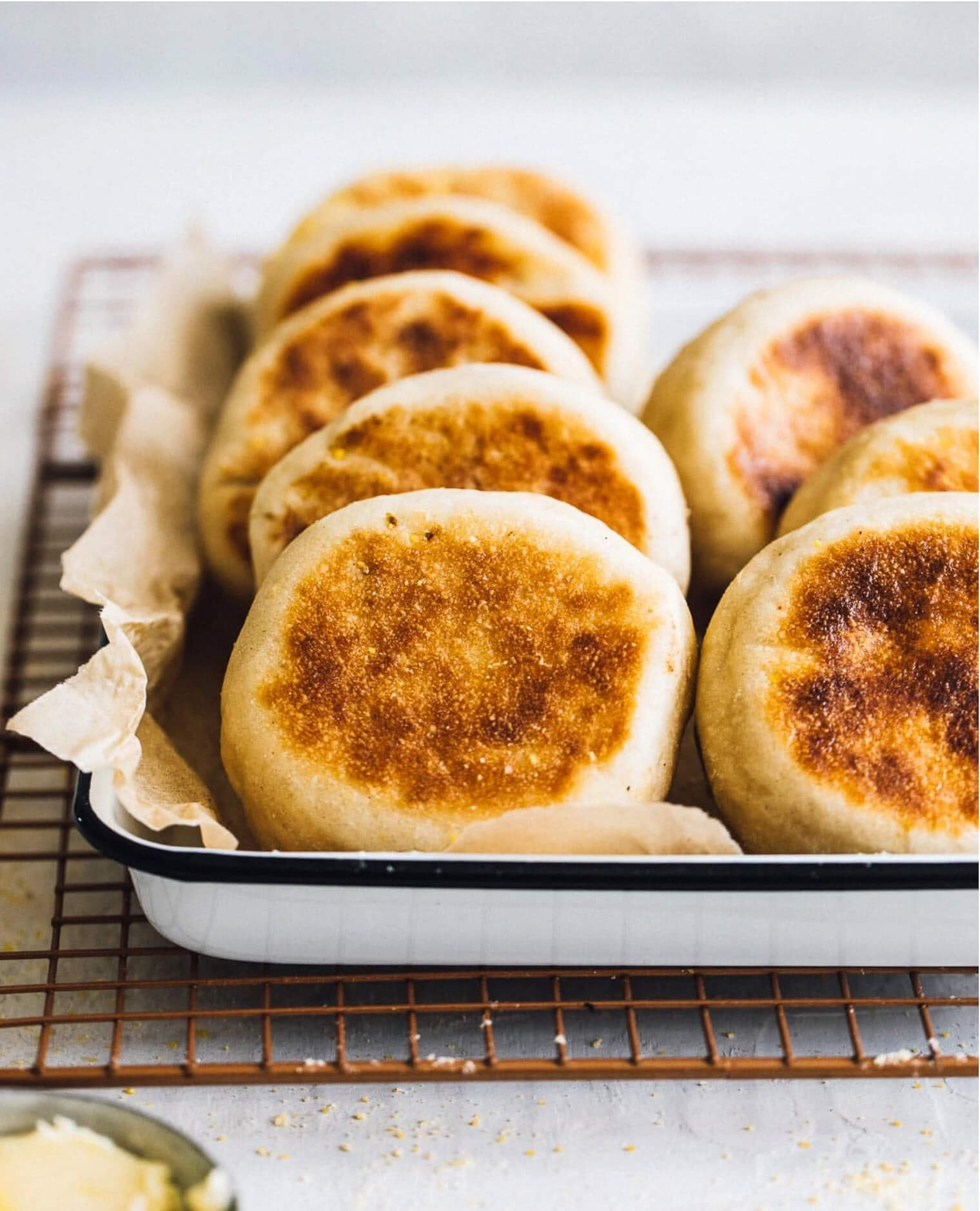 Homemade golden brown Sourdough English Muffins made on the griddle. 