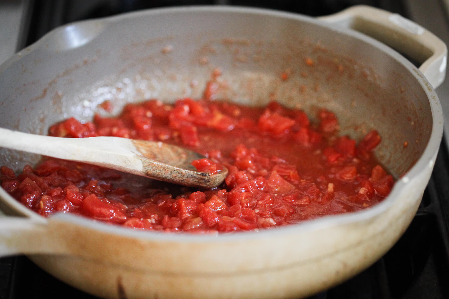Petite diced tomatoes simmer with herbs and garlic.