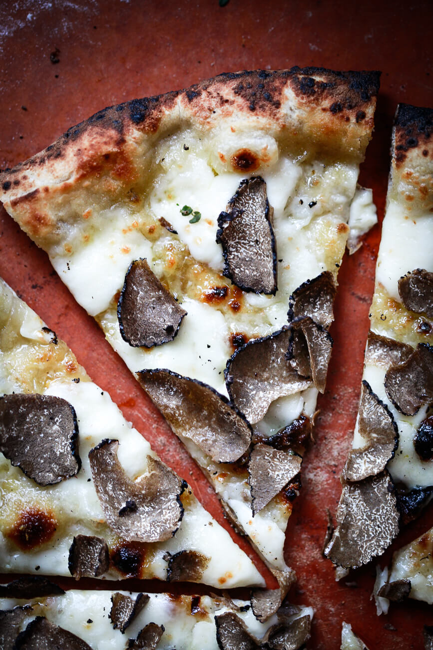A pizza recipe made with mozzarella and freshly shaved black truffles. 