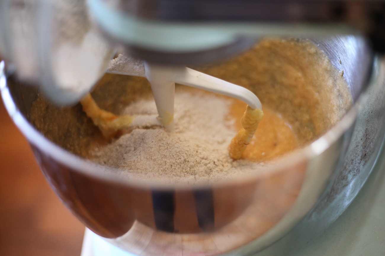 Dry ingredients are added to a mixer to make persimmon cookie dough.