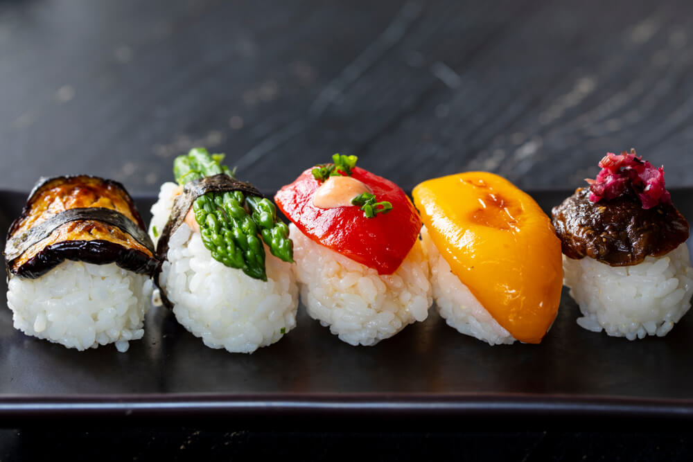 Vegetable nigiri rice topped with eggplant, asparagus, and peppers.