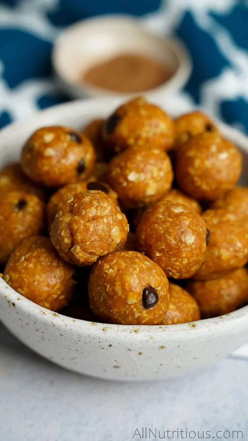A bowl of pumpkin protein balls with chocolate chips. 