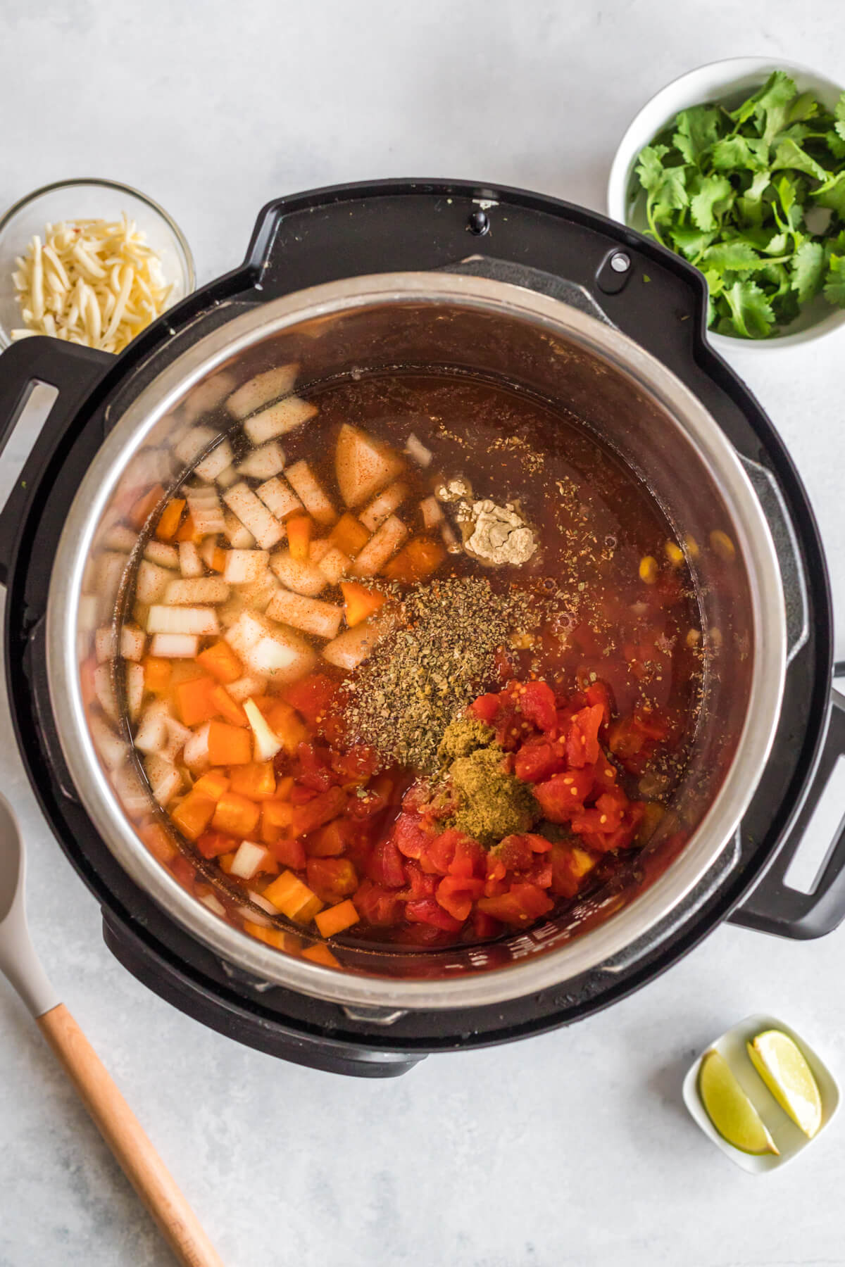 An overhead look into an Instant Pot filled with all the ingredients for vegetarian taco soup.