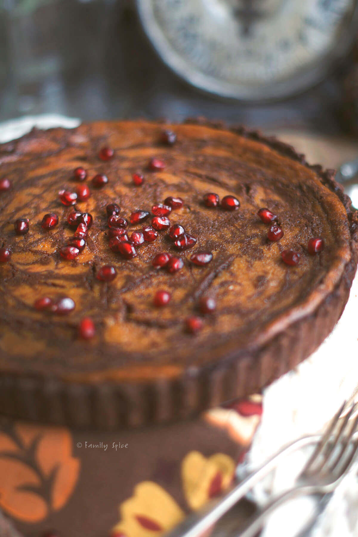 A double chocolate pumpkin pie topped with pomegranate arils. 