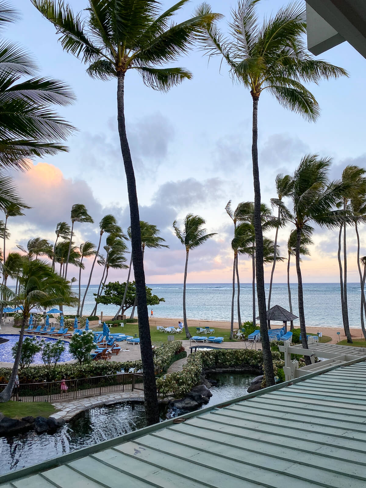 A sunset view looking out over the ocean, pool, and dolphin pool from the Veranda at the Kahala Hotel and Resort in Honolulu. 