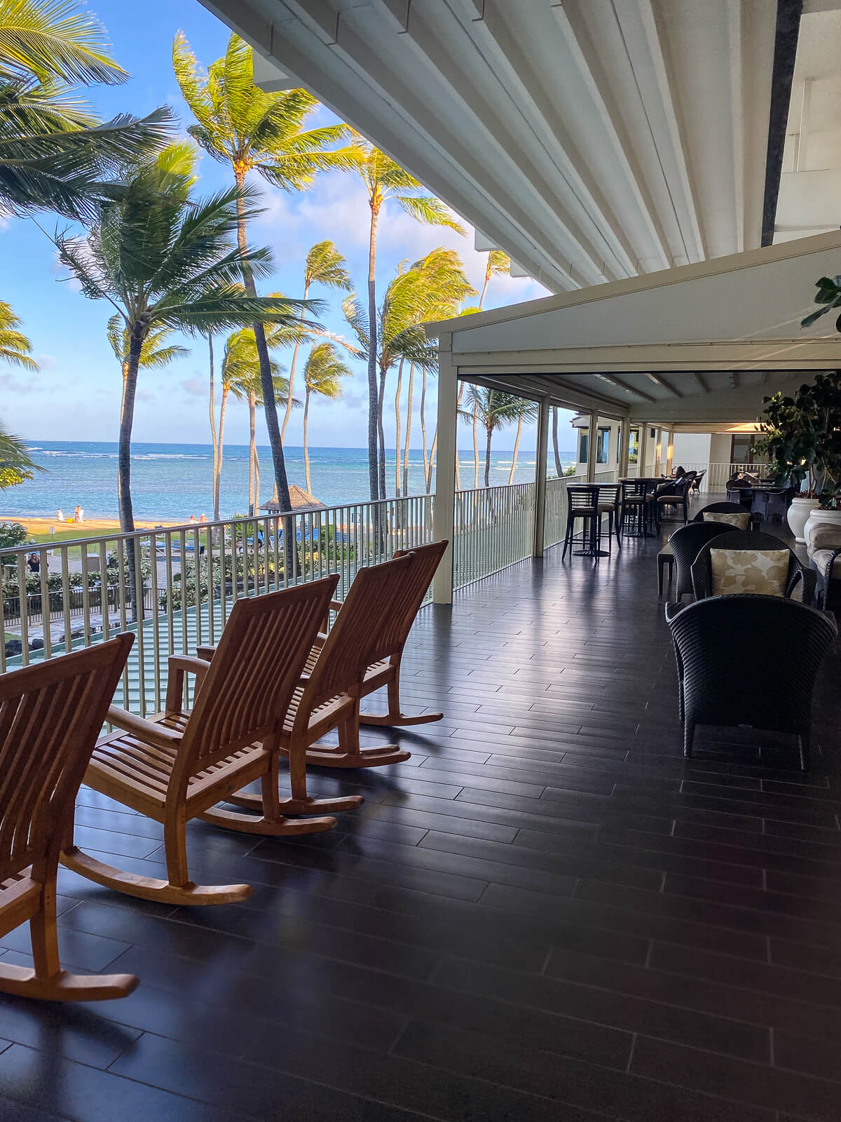 Wooden rocking chairs on the Veranda overlooking the ocean at the Kahala. 
