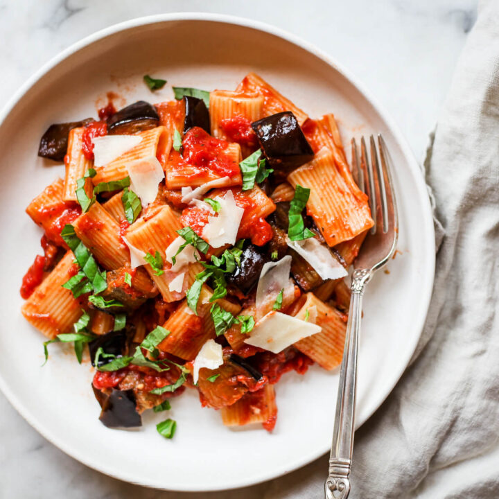 Pasta alla normal eggplant ragu on a white ceramic plate.