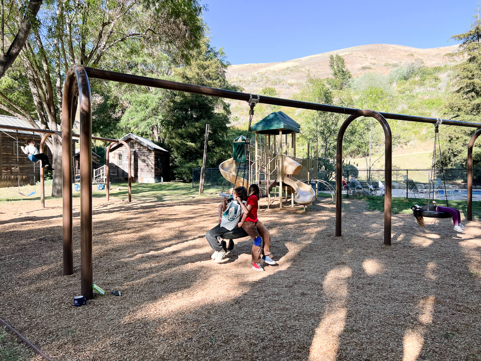 Kids play on a tire swing at the playground of the El Capitan Canyon resort. 