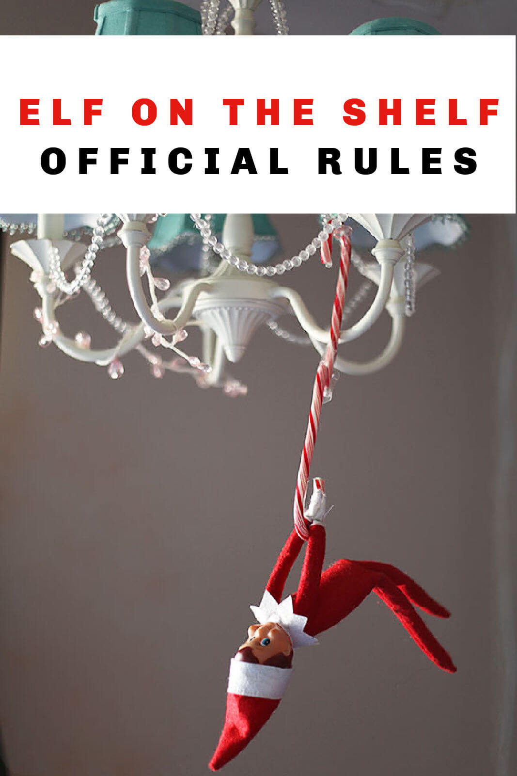An elf on the shelf hangs from a candy cane on a chandelier. Text overlay reads "ELF ON THE SHELF OFFICIAL RULES"