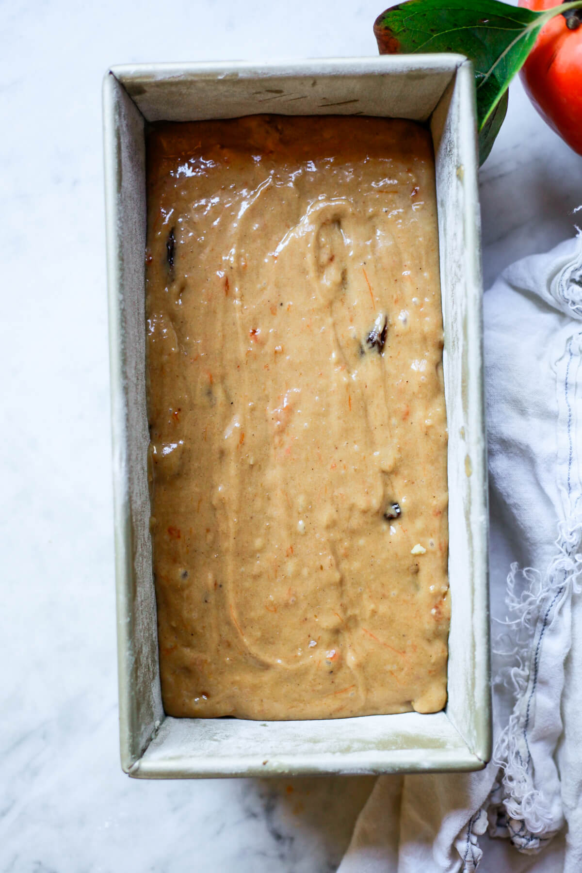 Persimmon bread batter in a loaf pan just before baking.