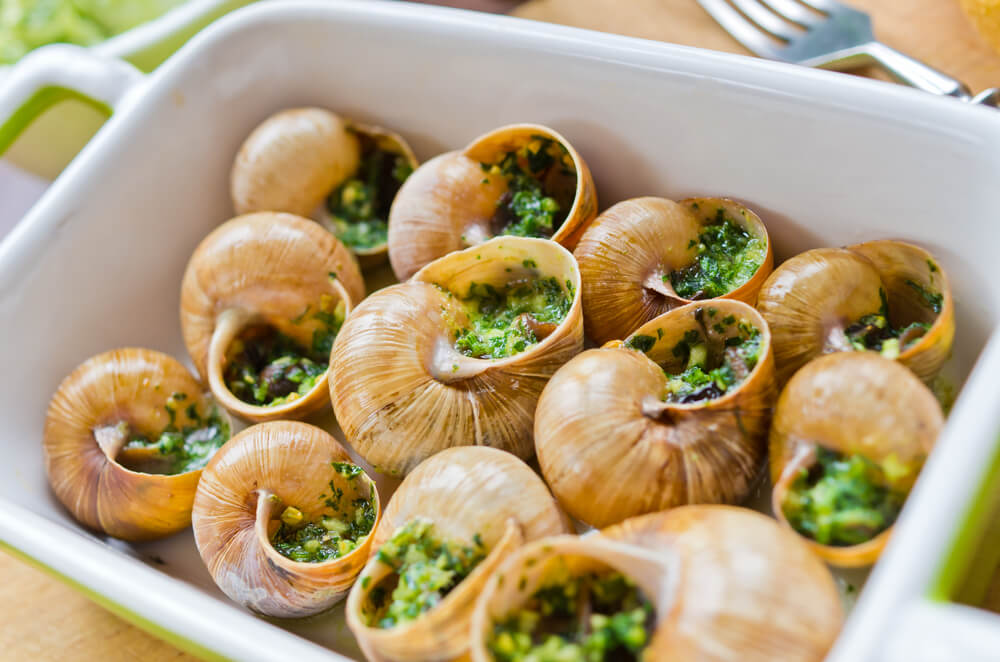 Escargots de Bourgogne (snails with parsley garlic butter) in a baking dish.
