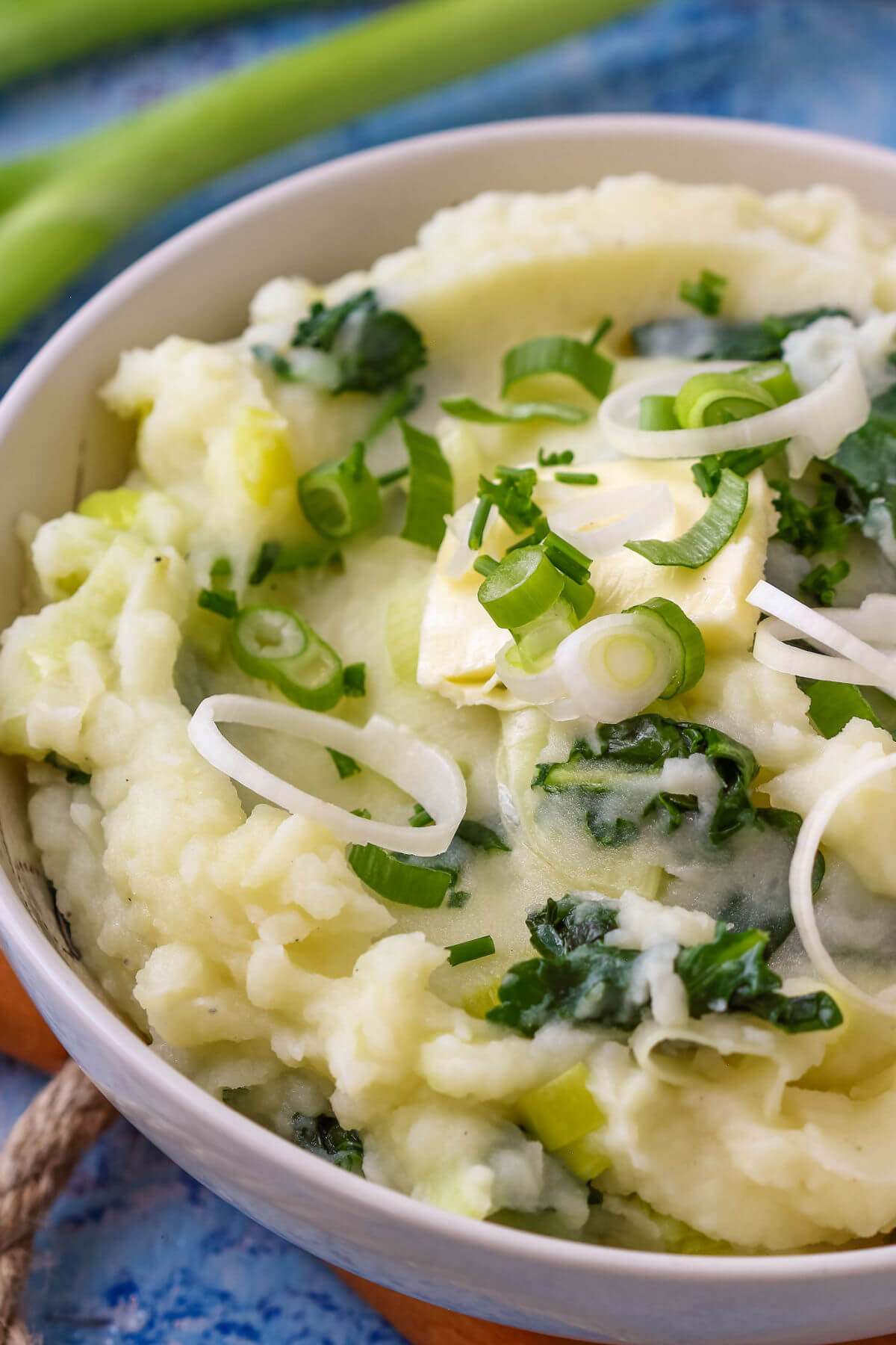 A close-up of colcannon, a traditional Irish recipe of mashed potatoes with kale, green onions, and leeks. 
