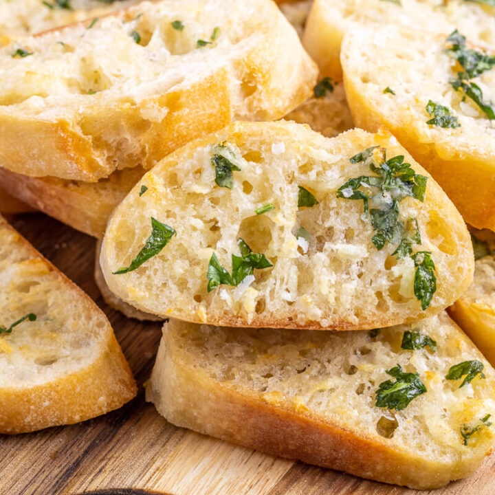 A photo of delicious air fryer garlic bread made on baguette slices and topped with parsley.