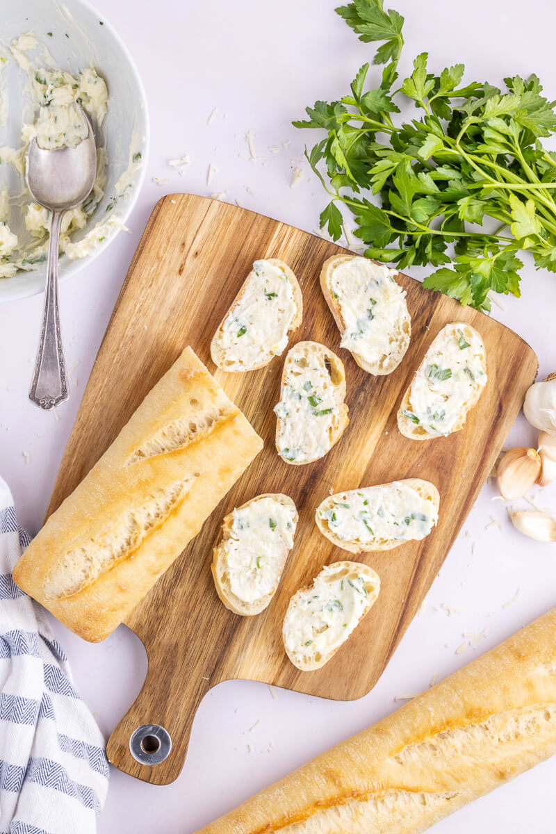Slices of baguette topped with garlic butter.