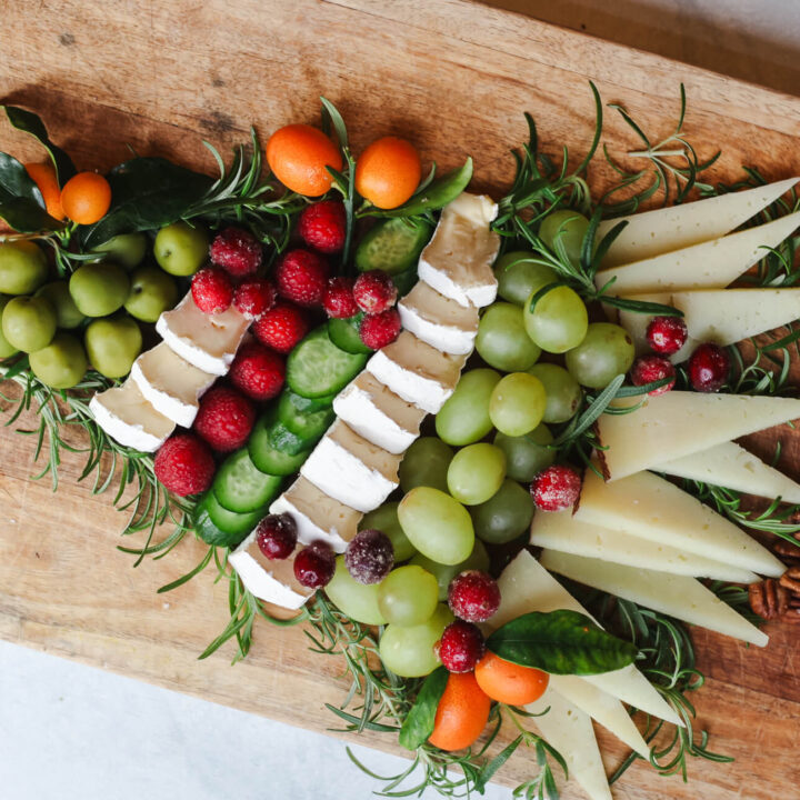 A cheese charcuterie board in the shape of a Christmas tree.