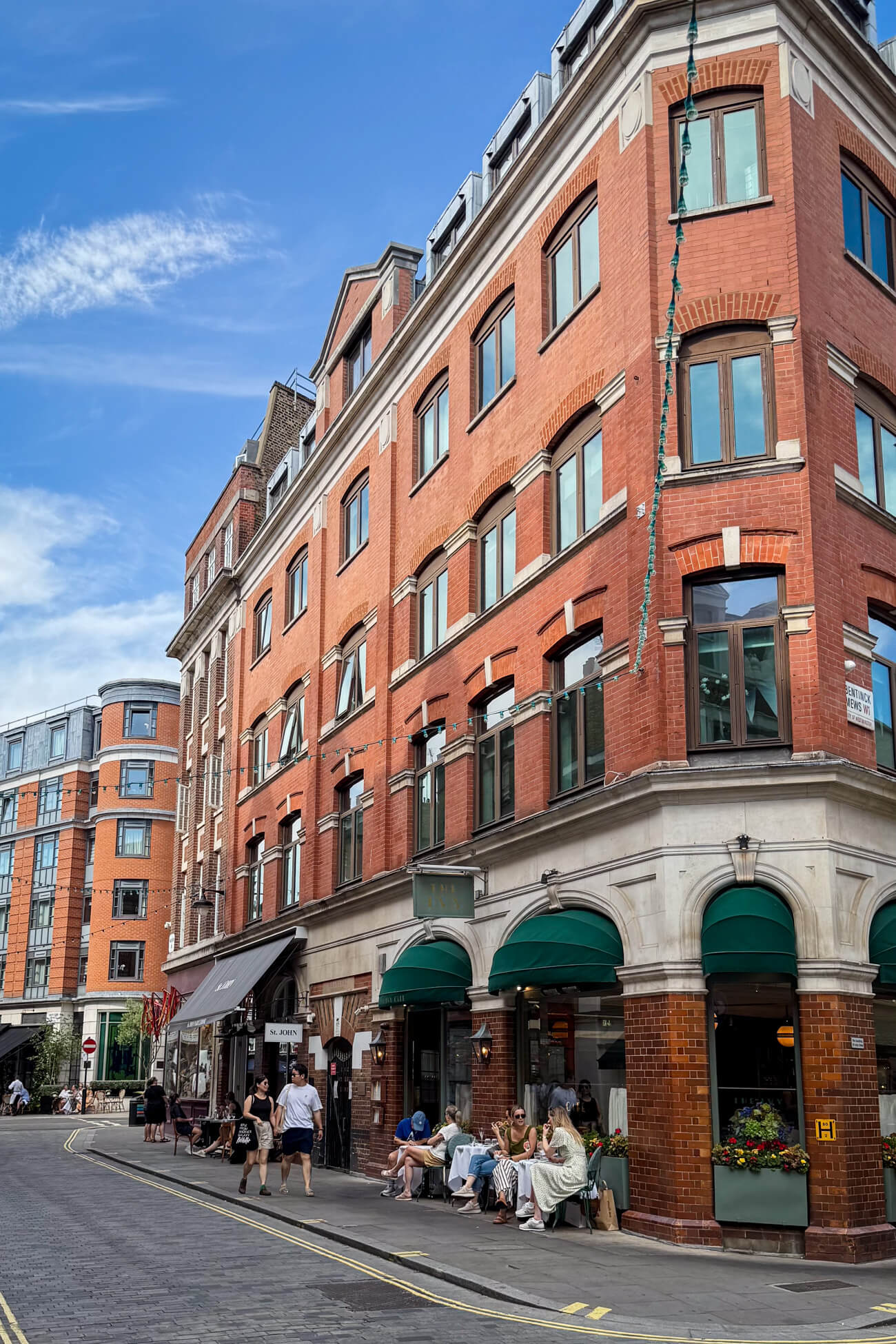People dine outside at The Ivy and St. John restaurants in the charming village of Marylebone in London. 