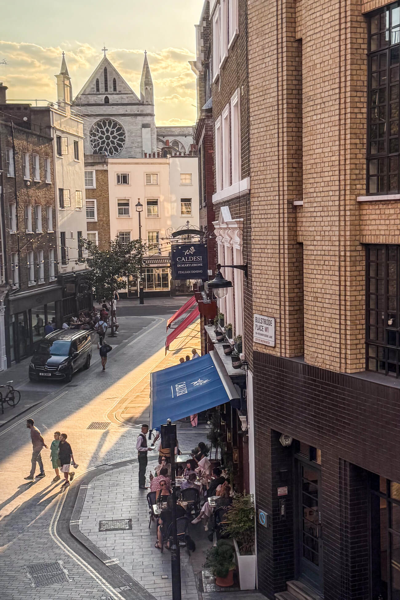 View from a window of Marylebone village with Caldesi restaurant in the foreground and a church in the background. 