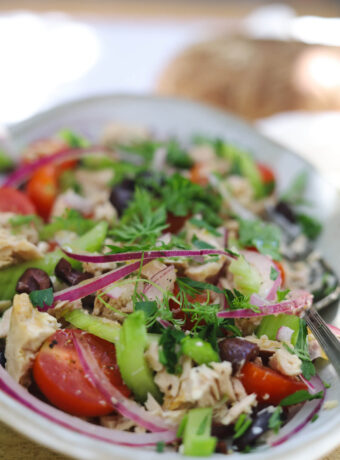 Mediterranean tuna salad with kalamata olives, cherry tomatoes, onions, celery, and herbs.