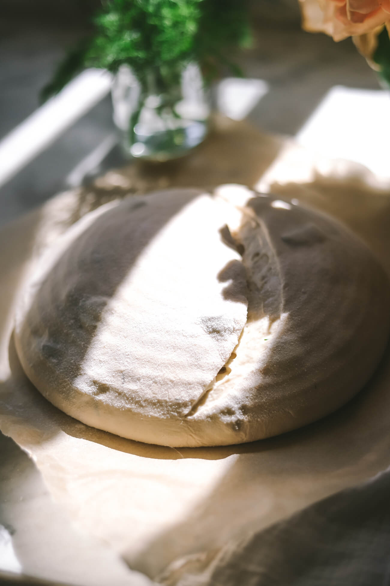 Dill pickle sourdough that has just been scored and is ready to bake.