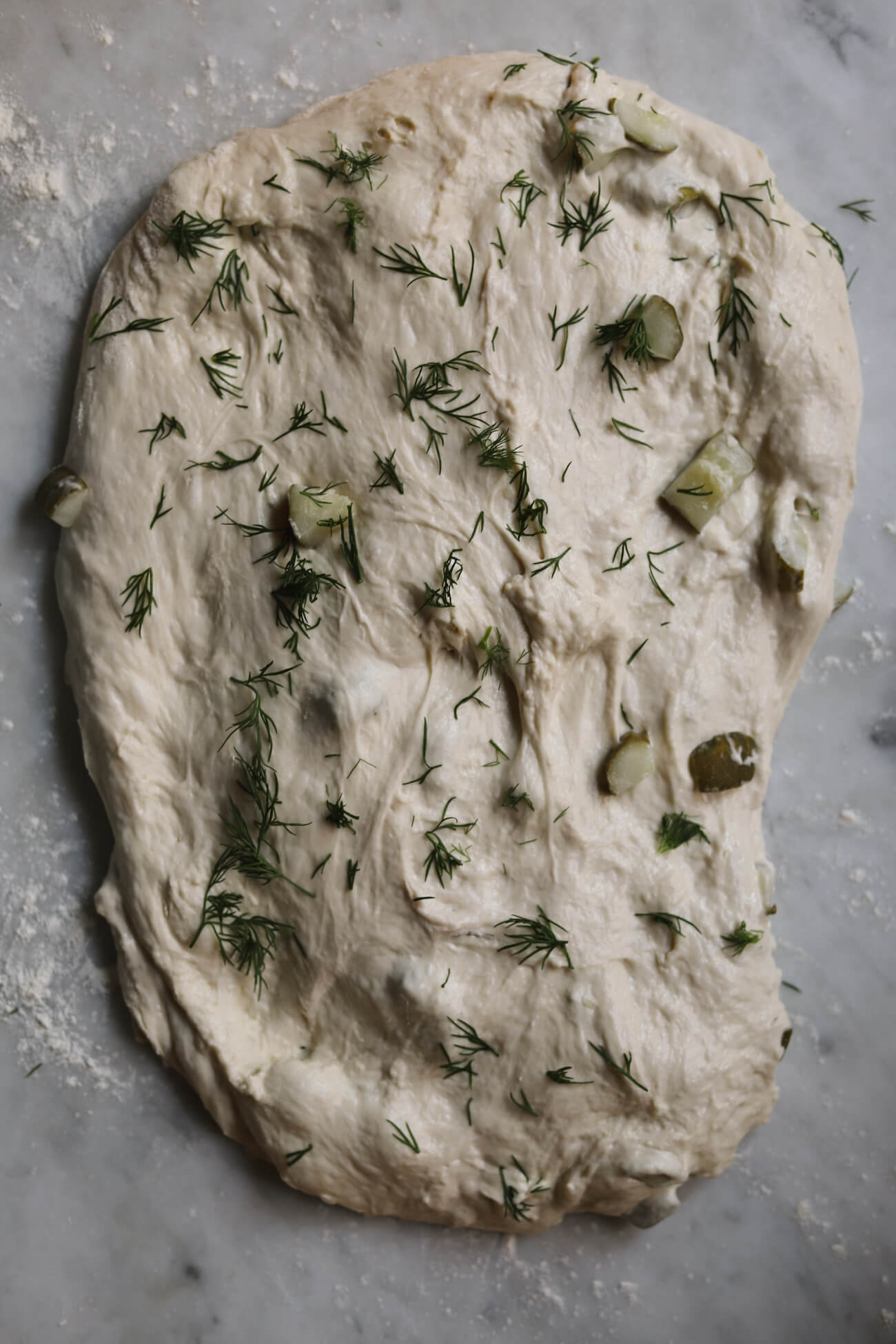 laminating dill pickle sourdough Dill pickle sourdough dough laminated with chopped pickles and fresh dill