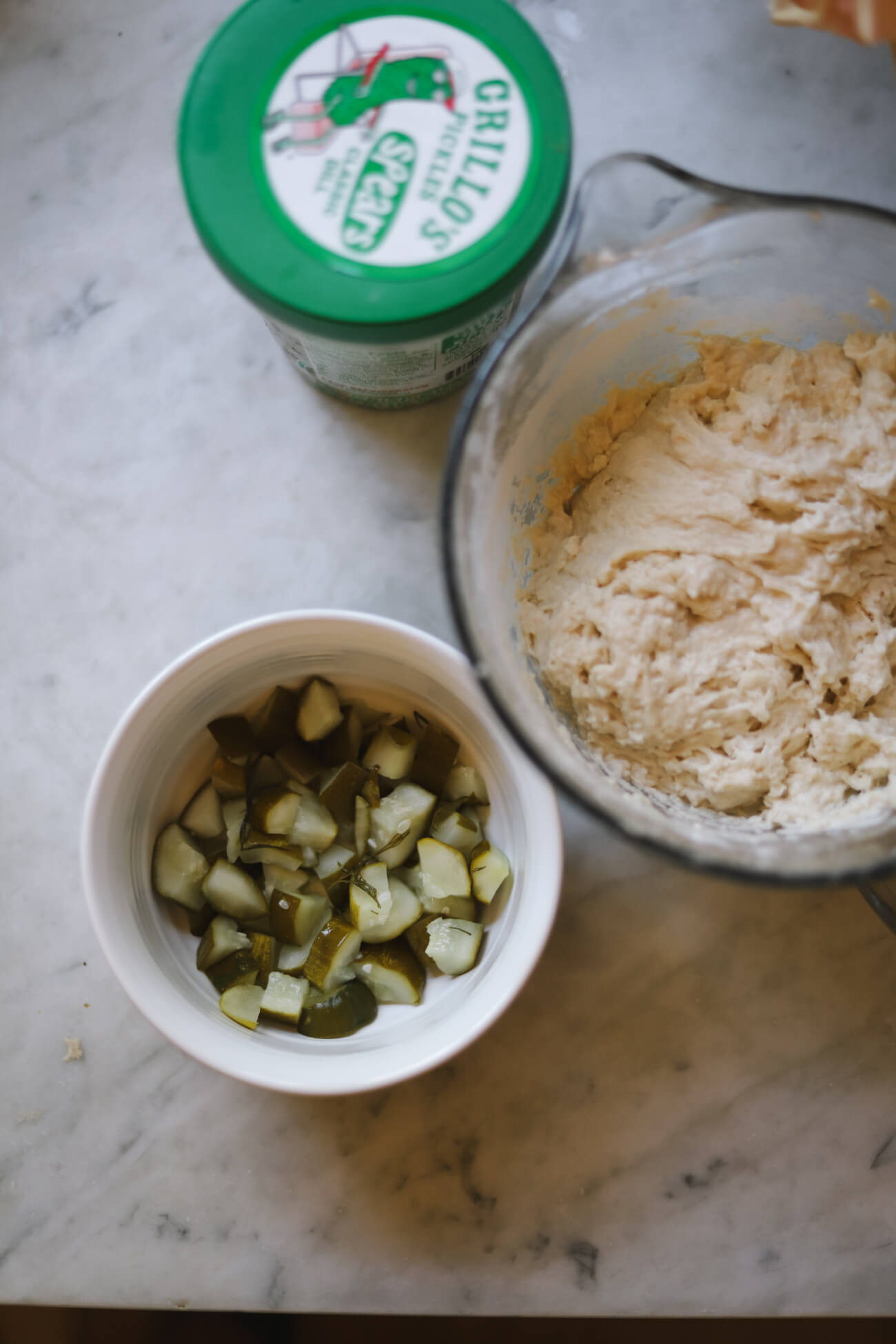 how to make dill pickle sourdough bread Chopped dill pickles beside high-hydration sourdough dough before mixing