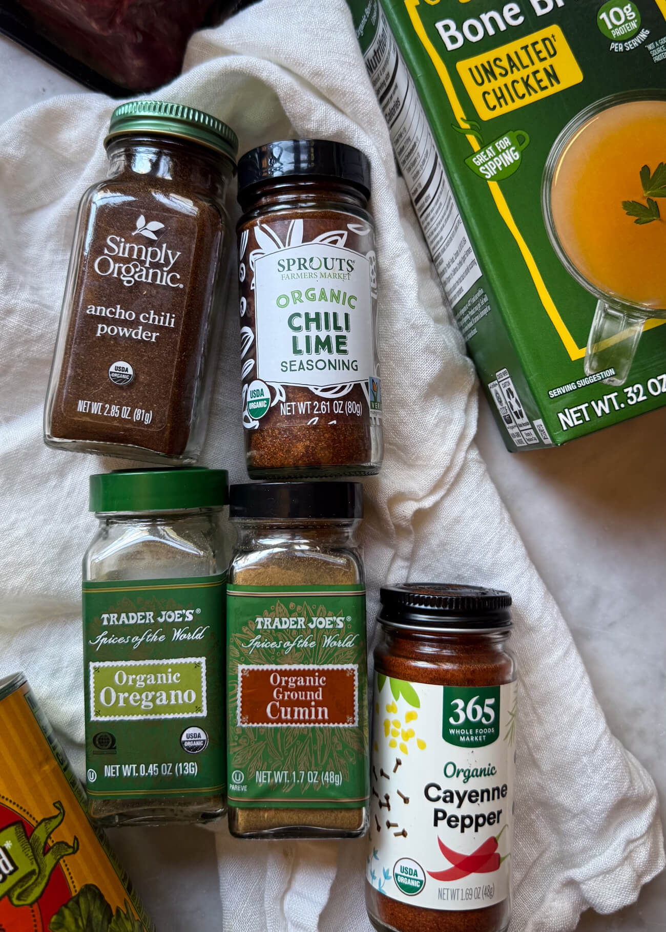 Low FODMAP Chili Spices and Broth Low FODMAP chili ingredients with ancho chile powder, chili-lime seasoning, cumin, oregano, cayenne pepper, and onion-free chicken bone broth