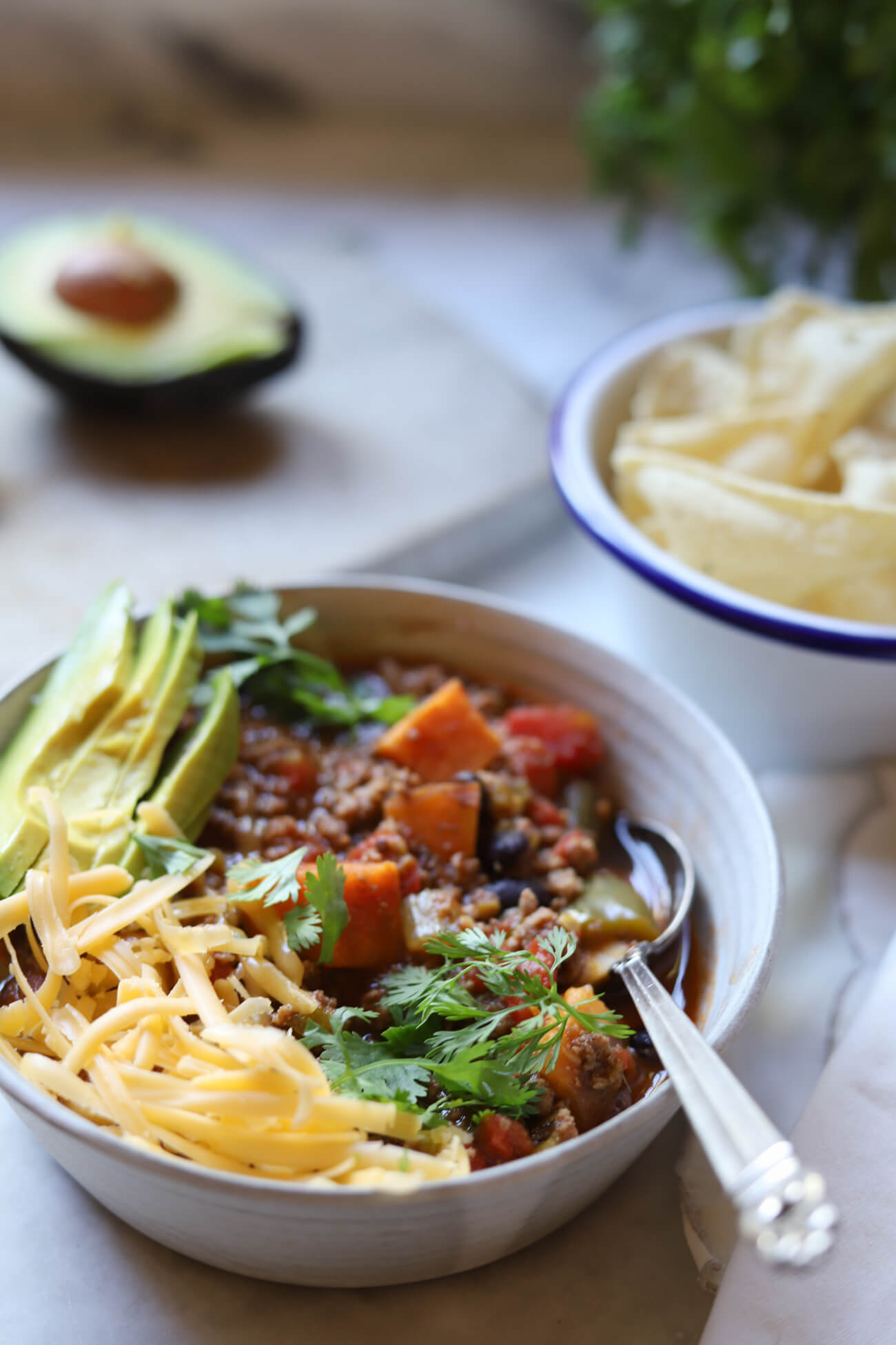Easy Low FODMAP Chili with Sweet Potatoes Low FODMAP chili with ground beef, sweet potatoes, cheddar cheese, avocado, and fresh cilantro