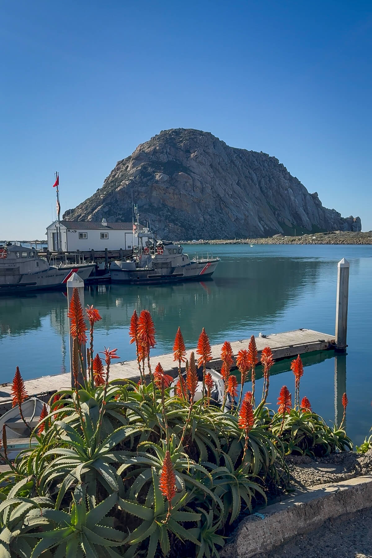 Morro Rock and Harbor in Morro Bay California Morro Rock overlooking the harbor and Coast Guard boats in Morro Bay, California