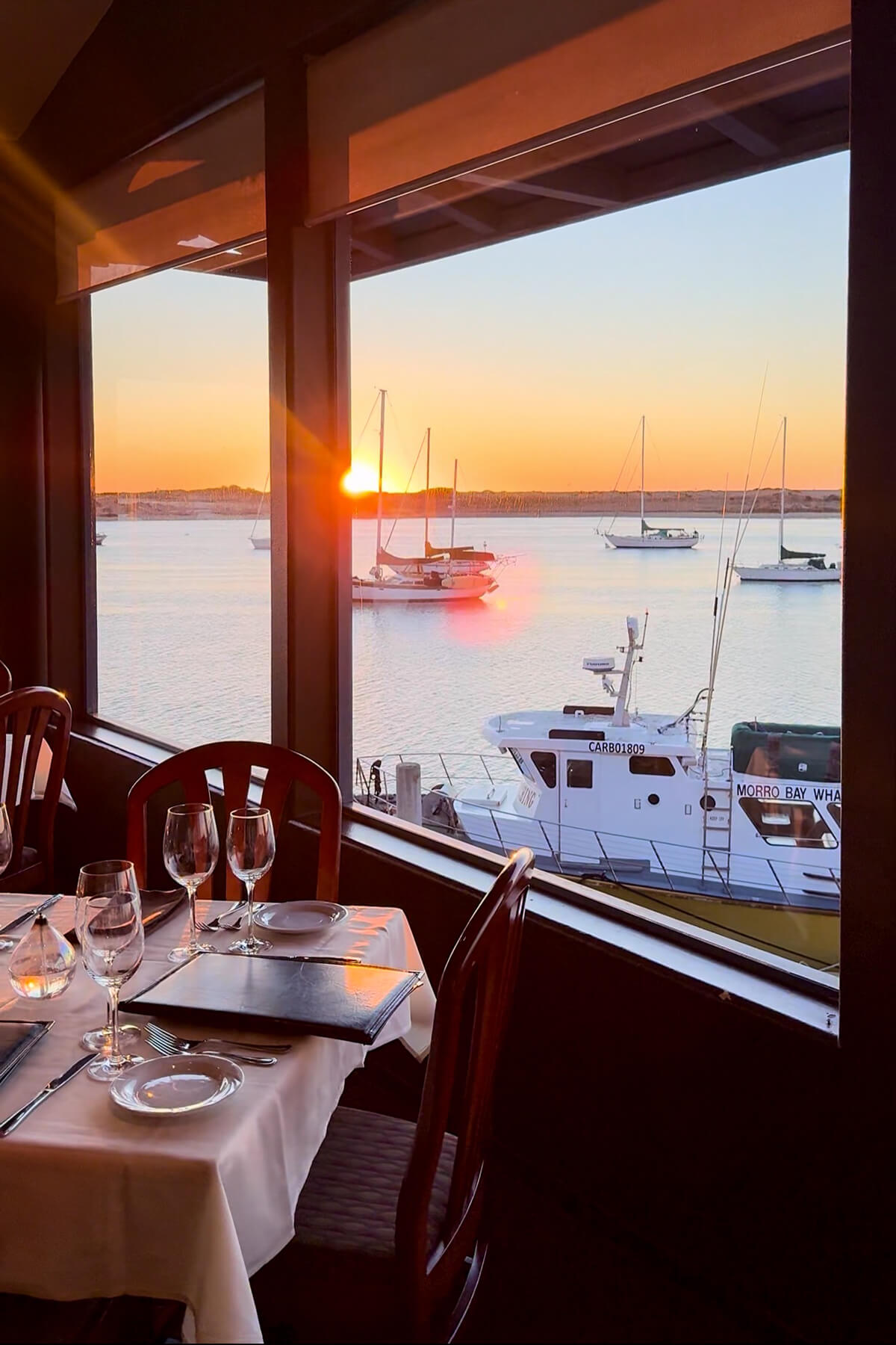 Windows on the Water, Morro Bat A table at Windows on the Water in Morro Bay with a view of the sunset over the bay.