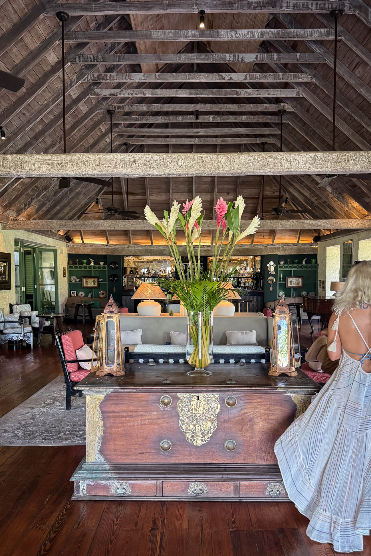 Cotton House Mustique Interior of the Cotton House on Mustique, with soaring wooden-beamed ceilings, tropical flowers, antique furnishings, and open-air Caribbean decor.