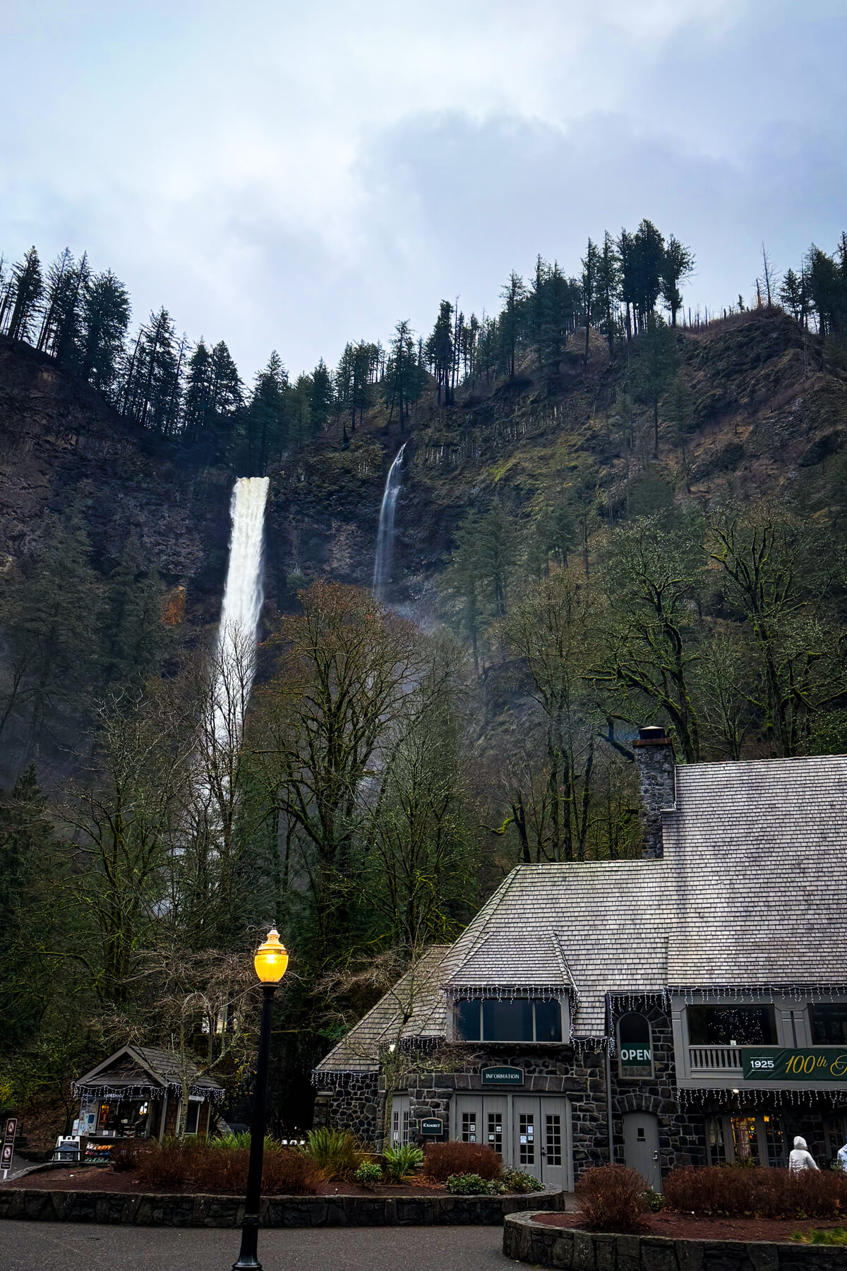 Multnomah Falls Lodge and Waterfall Multnomah Falls rising above Multnomah Falls Lodge in the Columbia River Gorge.